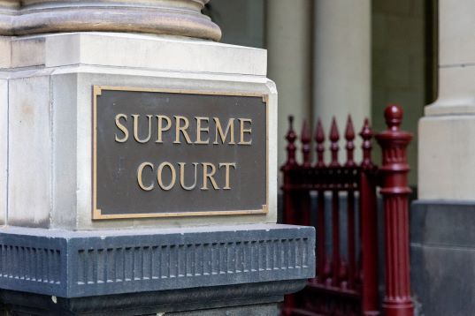 Supreme court bronze sign on pillar