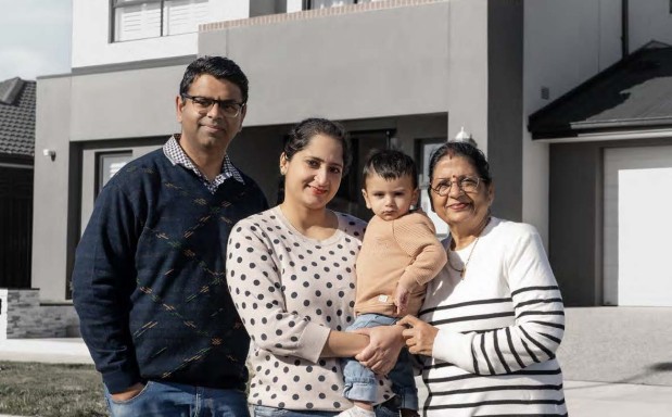 A family stand infront of their newly fiished home