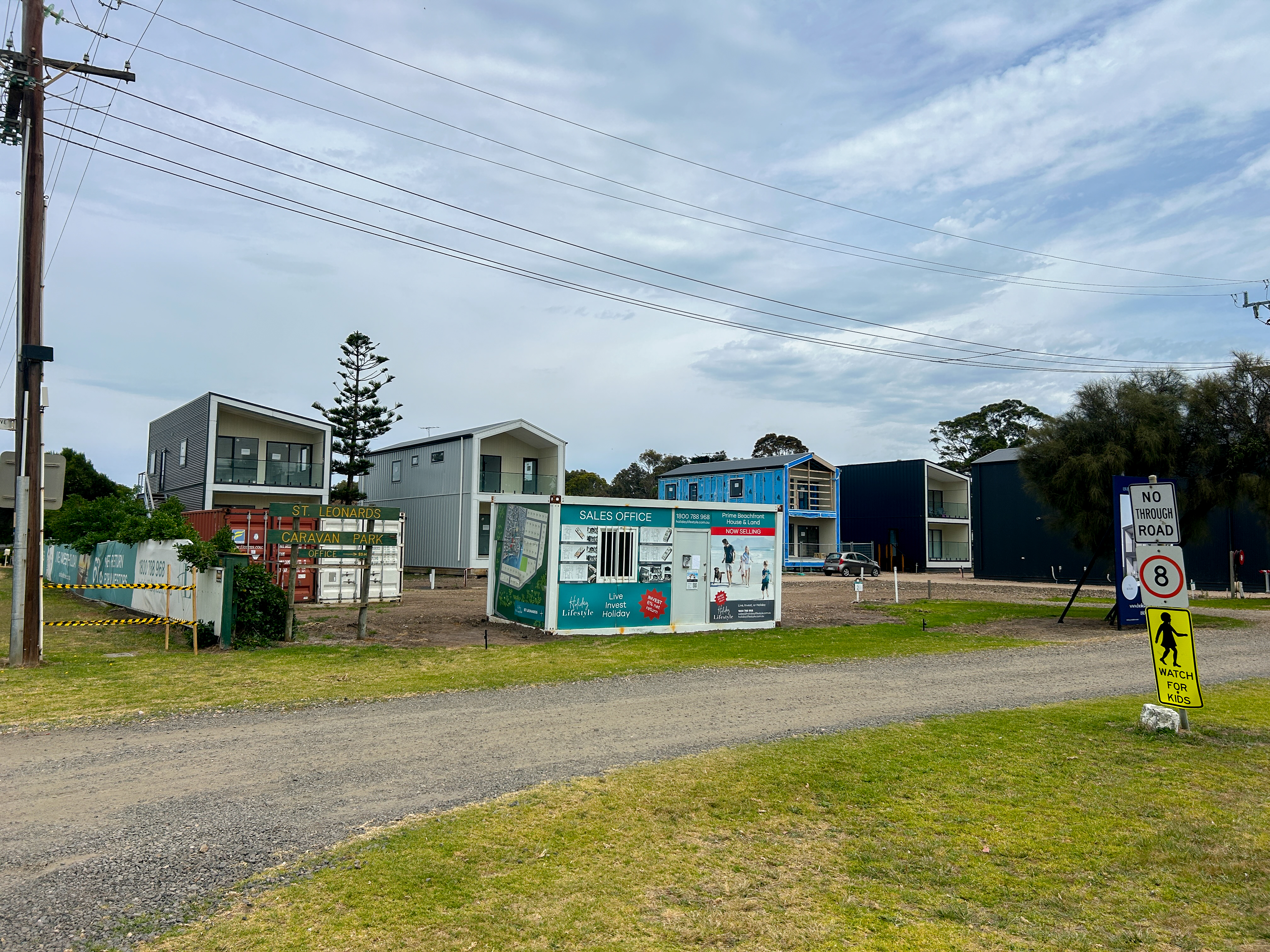 Buildings in progress on a grassy site with a sign that says St Leonards Caravan Park
