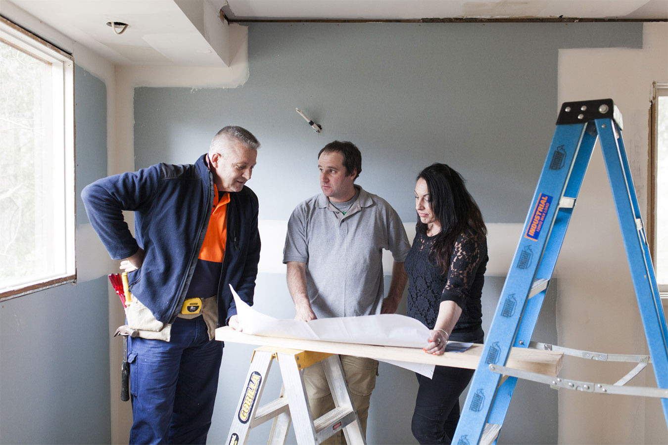 a builder working with clients on site